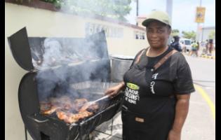Antionette Burke preparing chicken for hungry revellers along the Road March route on Sunday.
