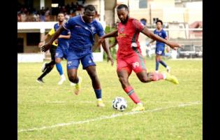 Montego Bay United’s Brian Brown (right) prepares to kick the ball as Spanish Town Police’s Shamar Harris (centre) reacts during their Jamaica Premier League football game at Jarrett Park in Montego Bay on Sunday. MoBay United won 6-0.