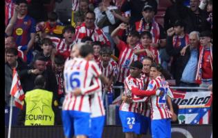 Atletico Madrid’s Ademola Lookman (third from right) celebrates with teammates after scoring his side’s opening goal during the Champions League quarterfinal second leg match against Barcelona in Madrid, Spain yesterday.