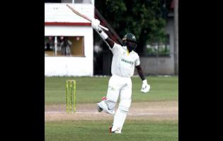 Jamaica Scorpions’ Kirk McKenzie Jr. celebrates scoring a century on the fourth day of the West Indies Championship cricket match against Barbados Pride at Chedwin Park, St Catherine on Wednesday.