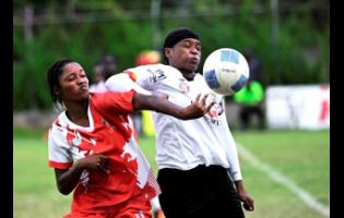 UWI’s Krystina Patterson (left) contends with Cavalier’s Jynel Graham during the Jamaica Women’s Premier League football encounter at the Alpha Institute on Saturday.