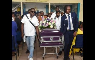 With measured steps, pallbearers escort the coffin bearing the remains of Kevaughn Goldson from King’s Chapel Seventh-day Adventist Church, Windward Road, Kingston, yesterday.