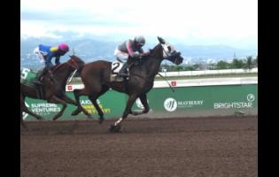 SLAM SHARP (right), ridden by Richie Shakes, wins the Aston Commock Memorial Trophy race at 20-1 ahead of LOCK DOWN, with Demar Williams aboard, at Caymanas Park yesterday.