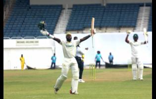 Jamaica Scorpions batsman Kirk McKenzie celebrates his century against the Barbados Pride at Sabina Park yesterday.