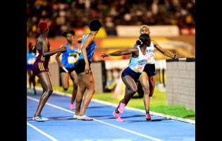 Edwin Allen (right) making the final baton exchange on the 4x400m open girls relay final ahead of Hydel High (centre) and Holmwood Technical at the ISSA GraceKennedy Boys and Girls’ Athletics Championships at the National Stadium in St Andrew, Jamaica, on Saturday, April 1, 2023. The three are among Jamaican institutions expected to contend for top honours at the upcoming Penn Relays.