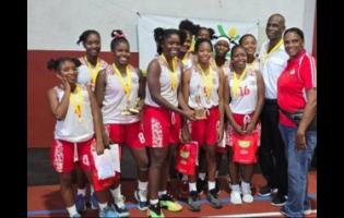 ISSA urban area schoolgirls basketball MVP Danae Brown (fourth from left) celebrates winning the title with teammates, Queen’s past student Olive McNaughton (right) and coach Donald Bimmer (second right), after they defeated St Andrew High 49-33 in the ISSA urban area final at UWI Bowl on Monday.