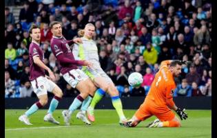 Manchester City’s Erling Haaland (second right) scores his side’s opening goal during the English Premier League soccer match against Burnley in Burnley, England, on Wednesday.