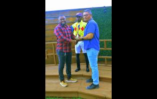 Winning jockey Tevin Foster (centre) poses with connections after guiding MABROUK to victory in the Sprint Trophy over five furlongs straight at Caymanas Park on Sunday.