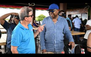 Tourism Minister Edmund Bartlett (right) engages with Jack Sprat Restaurant owner and hotelier, Jason Henzell, during a visit to the Lovers’ Leap attraction in St Elizabeth last Friday, as part of the second day of the South Coast Confidence Tour.