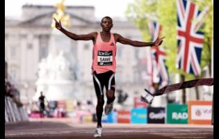 Sebastian Sawe from Kenya crosses the finish line to win the men’s race at the London Marathon in London on Sunday.