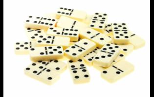 pile of scattered dominoes on isolated white background