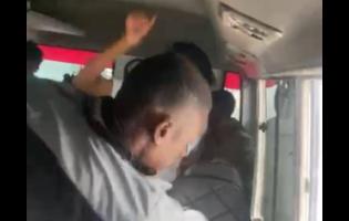 A screenshot from a video showing a bus conductor assaulting two Corporate Area schoolgirls.