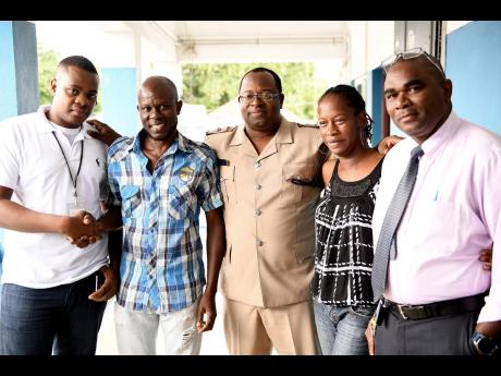 Ricardo Makyn/Chief Photo Editor
Elated parents Sinclair Hutton (second left) and Suzett Whyte, thank policemen (from left) Detective constable Morvin Ellis, Superintendant Howard Chambers and Detective Inspector Phillip Dodd at the Denham Town Police Station after news broke that their baby that was stolen from the Victoria Jubilee Hospital had been found.
