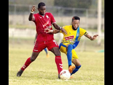 UWI FC’s Dwayne Smith (left) tackles Odane Samuels of Harbour View FC during their Red Stripe Premier League match held at the UWI Mona Bowl in St Andrew on Wednesday, January 9.  
