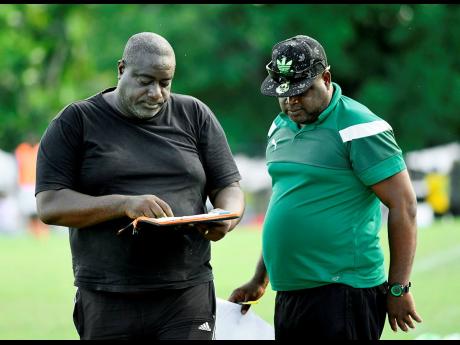 Humble Lion head coach Glendon ‘Admiral’ Bailey and his assistant Lijyasu Simms discuss tactics during a Red Stripe Premier League game at the Effortville Community Centre on Sunday, October 21, 2018.