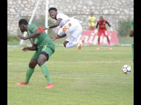 
Humble Lion’s Oneil ‘Bigga’ Thompson (left) sends Portmore United’s Donnegy Fer flying from a hard tackle in their Red Stripe Premier League clash at the Spanish Town Prison Oval on Sunday, September 30, 2018.