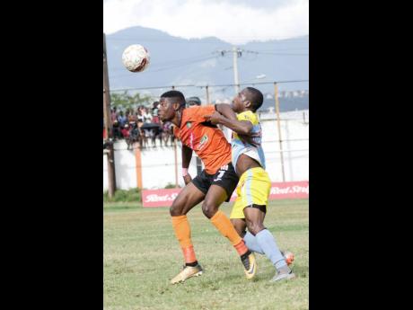 
Tivoli Gardens FC’s Junior McGregor jostles for the ball with Waterhouse FC’s Tramaine Stewart (right) in their Red Stripe Premier League game at the Edward Seaga Complex on Sunday, March 4, 2018. 