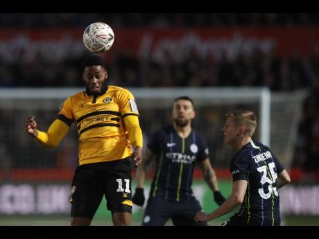  AP
Newport County’s Jamille Matt (left) heads the ball past Manchester City’s Oleksandr Zinchenko during their English FA Cup fifth round match at Rodney Parade stadium in Newport, Wales, on Saturday, February 16.