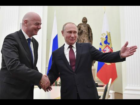  AP
Russian President Vladimir Putin (right) welcomes FIFA President Gianni Infantino for talks in the Kremlin in Moscow, Russia, yesterday. 