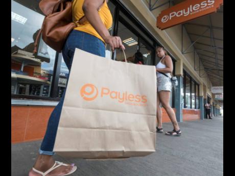 Gladstone Taylor
A Payless customer after making a purchase as the Springs Plaza store located on Constant Spring Road in Kingston. 
