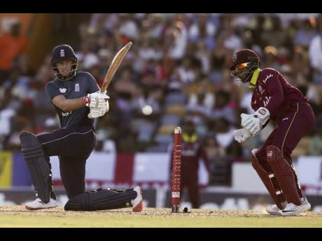 ap photos
England’s Joe Root sweeps a shot against the Windies during the first one-day international cricket match at the Kensington Oval in Bridgetown, Barbados, yesterday.