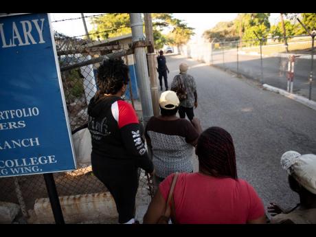Numerous persons outside Harman Barracks await relatives and friends who were among the 29 deportees from the United Kingdom who returned to Jamaica earlier this month. 