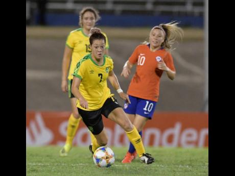 Credit: Andre Lowe Reggae Girl Chinyelu Asher (centre) is all focus during Jamaica's 1-0 win over Chile in their friendly international at the National Stadium last night.