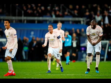 AP
Man U defender Chris Smalling (centre) celebrates ManU’s Marcus Rashford’s goal during the Champions League round-of-16, second leg match between Paris Saint Germain and Manchester United at the Parc des Princes stadium in Paris, France, yesterday. 