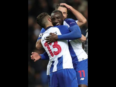 ap
Porto goalscorers forward Moussa Marega (centre) and defender Alex Telles (left) celebrate at the end of the Champions League round-of-16 second-leg, match between FC Porto and AS Roma at the Dragao stadium in Porto, Portugal, yesterday. 