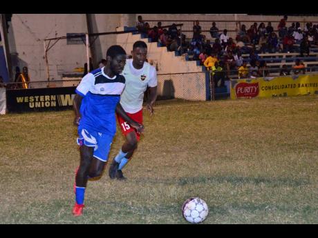 Brown’s Town FC’s Romario Ward (left) dribbles away from Central Kingston FC’s captain, Donovan Alvaranga, during their recent first-round Magnum KSAFA Super League football match at the Harbour View Mini-Stadium.