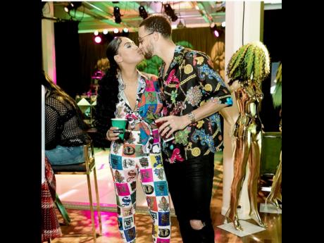 Ayesha Curry and her husband Steph share a kiss at her Jamaican themed surprise birthday party.