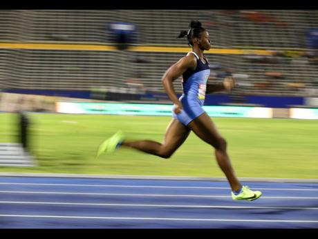Credit: Gladstone Taylor Edwin Allen’s Kevona Davis winning her heat in the Class Two girls 200m on the opening day of the ISSA/GraceKennedy Boys and Girls’ Championships at the National Stadium yesterday.