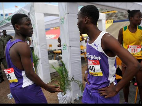 Credit: Shorn Hector SHORN HECTOR
Giovouni Henry (left) of Kingston College talks with twin brother Gianni after competing in the Class Two boys 800m semi-finals on day three of the ISSA/GraceKennedy Boys and Girls’ Athletics Championships.