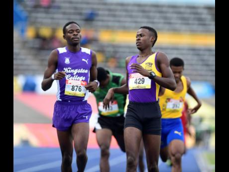 Credit: Gladstone Taylor Tyrice Taylor (right) of Enid Bennett High gets to the line ahead of Tarees Rhoden of Kingston College in heat one of the Class One boys 800 metres.