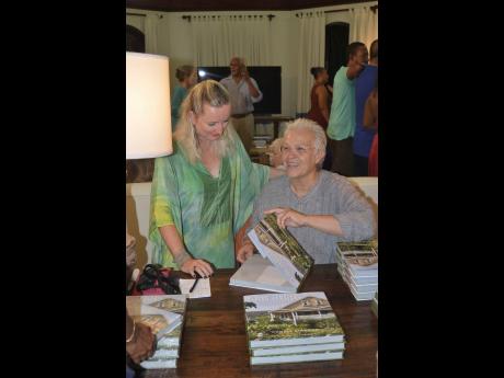 Photographer Cookie Kinkead (right) jokes with Katrin Casserly, chairman of Hanover Charities, at her book signing. 