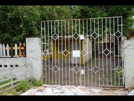 The premises on McIntosh Drive, off Mountain View Avenue, in St Andrew, where a man hanged himself after trying to kill his spouse. 