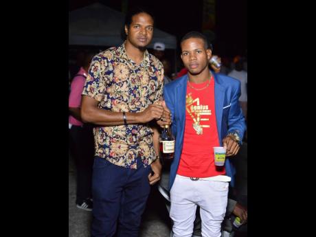 Olympian Jermaine ‘Speedy’ Gonzales (left) chills with his friend, Kritical, at D’Angel’s birthday celebrations at Lip Stick Parking Lot, Bayside, Portmore, St Catherine, last Friday.
