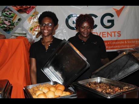 Kyria Simpson (left) and Paula Waysome of GCG Events give us a peek at what their VIP menu includes.