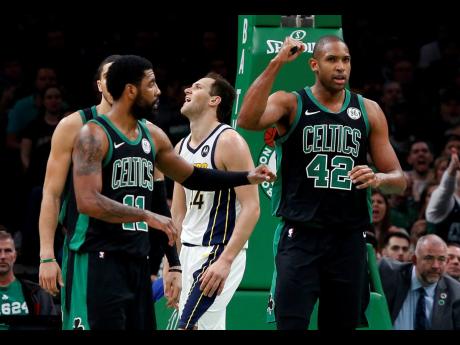 Boston Celtics’ Al Horford (42) pumps his fist after being fouled while making a basket by Indiana Pacers’ Bojan Bogdanovic (rear) during the second quarter in Game 1 of a first-round NBA basketball play-off series yesterday.