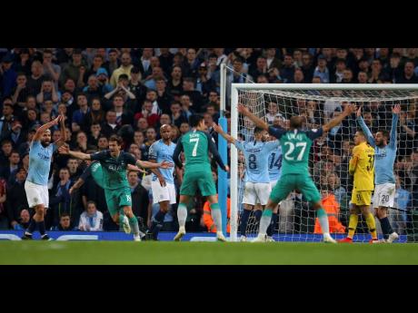 Tottenham’s Fernando Llorente (second left) celebrates scoring his side’s third goal as Manchester City’s Sergio Aguero (left) appeals for handball, watched by Manchester City’s Vincent Kompany (third left) during their second leg UEFA Champions League quarter-final match at the Etihad Stadium in Manchester, England, yesterday.