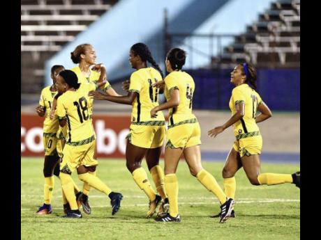 Jamaica’s Reggae Girlz celebrate a goal during their 4-1 win over Trinidad and Tobago at the CONCACAF Caribbean Women’s Qualifiers at the National Stadium last summer. 