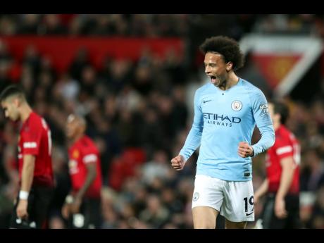 Manchester City’s Leroy Sane celebrates after scoring his side’s second goal during the English Premier League match against rivals Manchester United at Old Trafford in Manchester, England, yesterday.
