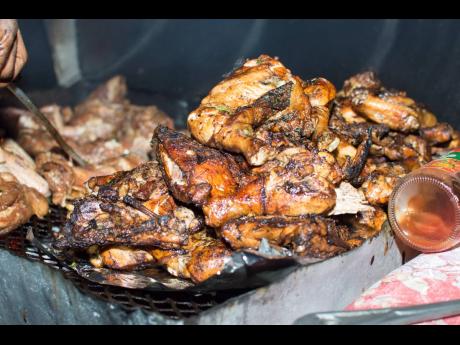Credit: File Jerked chicken is among the food sold on the streets of Kingston.