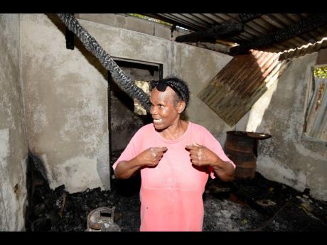 Cochita Hines from Tavern Drive in Papine, St Andrew, stands in what’s left of her home.