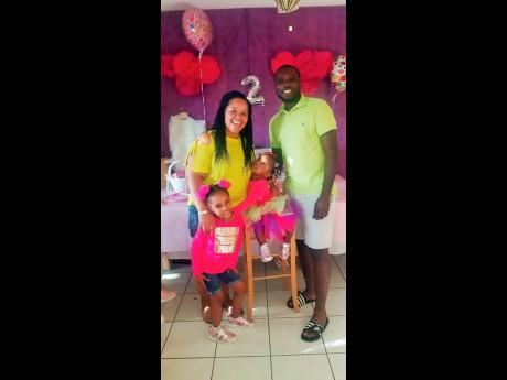 Annette and Carlos Bennett with their daughters Keanna (standing) and Akeena, at Akeena’s second birthday party.