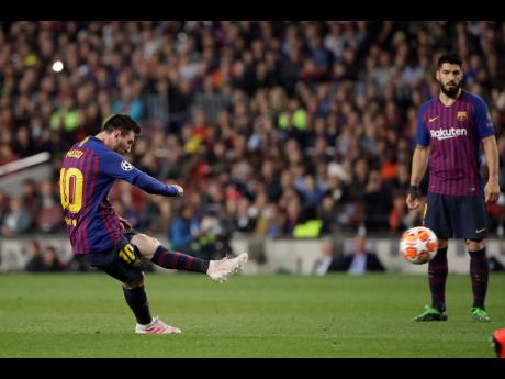 Barcelona’s Lionel Messi hits a spectacular free kick to score his side’s third goal during the first-leg UEFA Champions League semi-final match against Liverpool at Camp Nou in Barcelona, Spain,yesterday. 