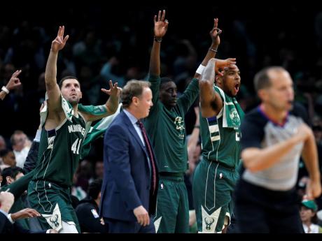 The Milwaukee Bucks bench reacts to a three-point basket during the second half of Game 4 of a second round NBA basketball play-off series against the Boston Celtics in Boston on Monday.