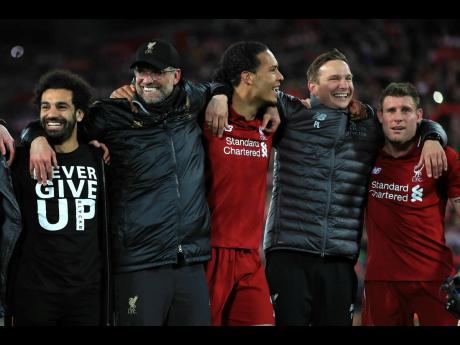 From left: Liverpool’s Mohamed Salah, Manager Jurgen Klopp, Virgil van Dijk, Assistant Manager Pepijn Lijnders, and James Milner celebrate after the Champions League semi-final, second-leg match between Liverpool and Barcelona at Anfield, Liverpool, England, yesterday. Liverpool won the match 4-0 to overturn a three-goal deficit to win the match 4-3 on aggregate. 