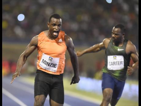 Jevaughn Minzie (left) wins the Men’s 100m A race ahead of Nesta Carter at the Racers Adidas Grand Prix at the National Stadium last year. 