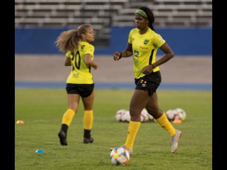 Khadija Shaw (right) at a Reggae Girlz training session held at the National Stadium yesterday, ahead of an international friendly match against Panama this Sunday. Also pictured is newcomer Madiya Harriott. 